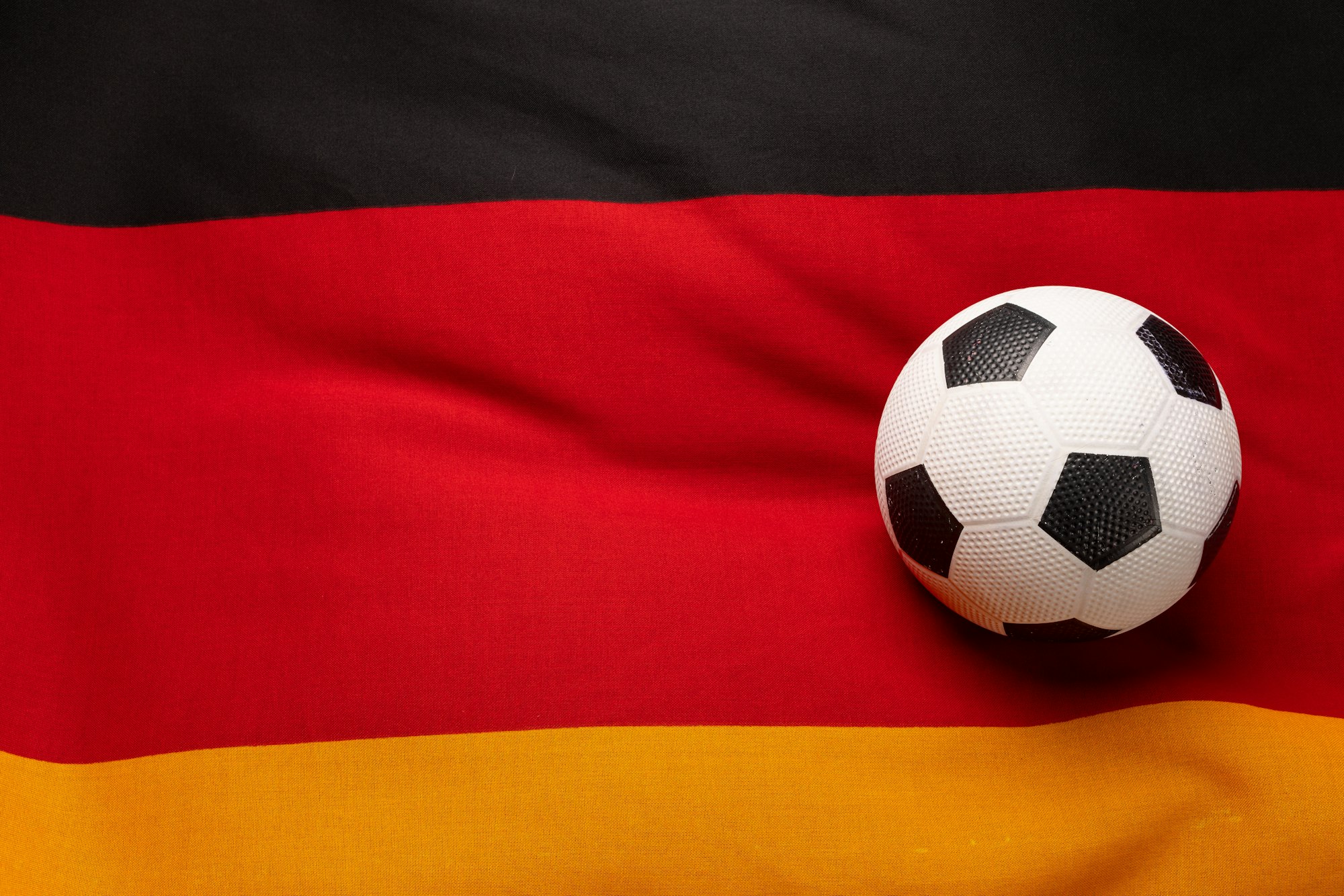 Composition of football over national flag of germany